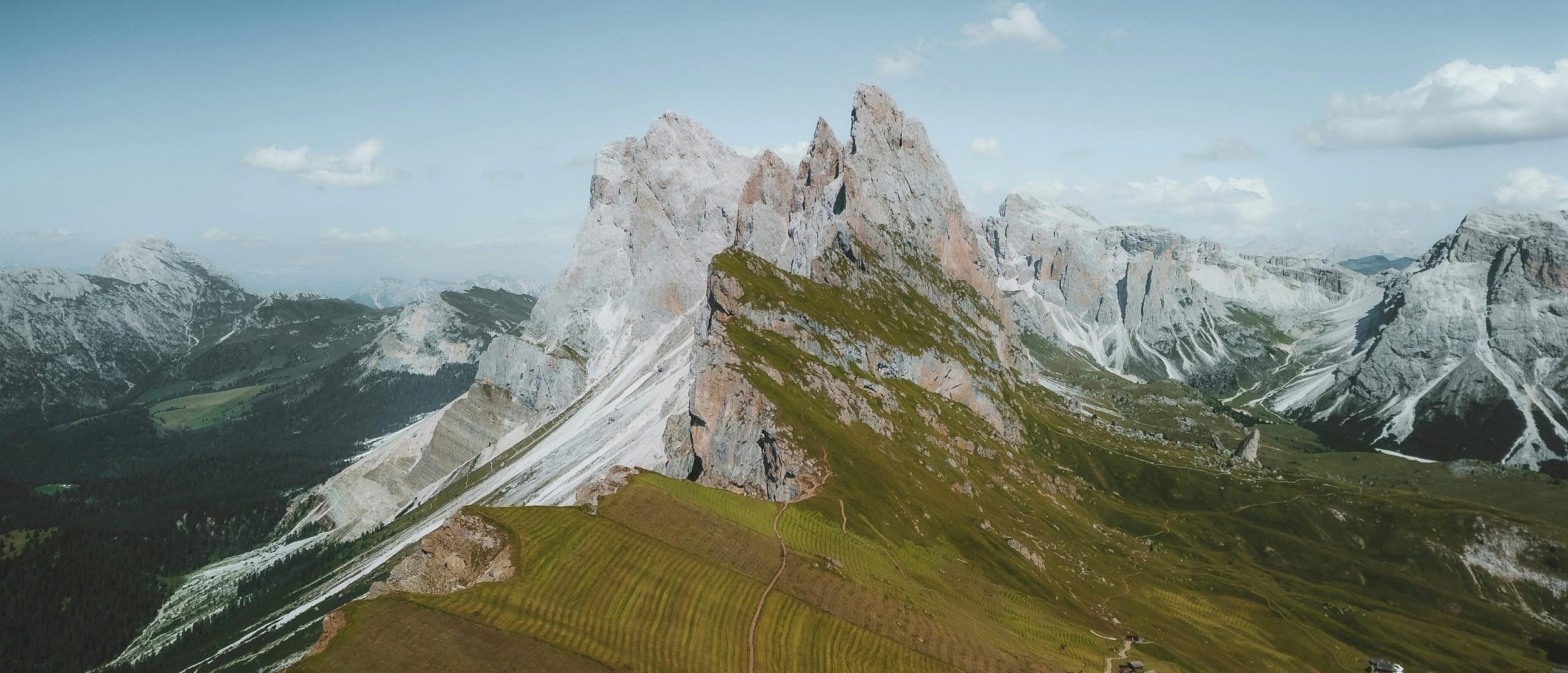 A breathtaking aerial view of the Seceda Ridge in the Dolomites showcasing dramatic peaks and lush landscapes.